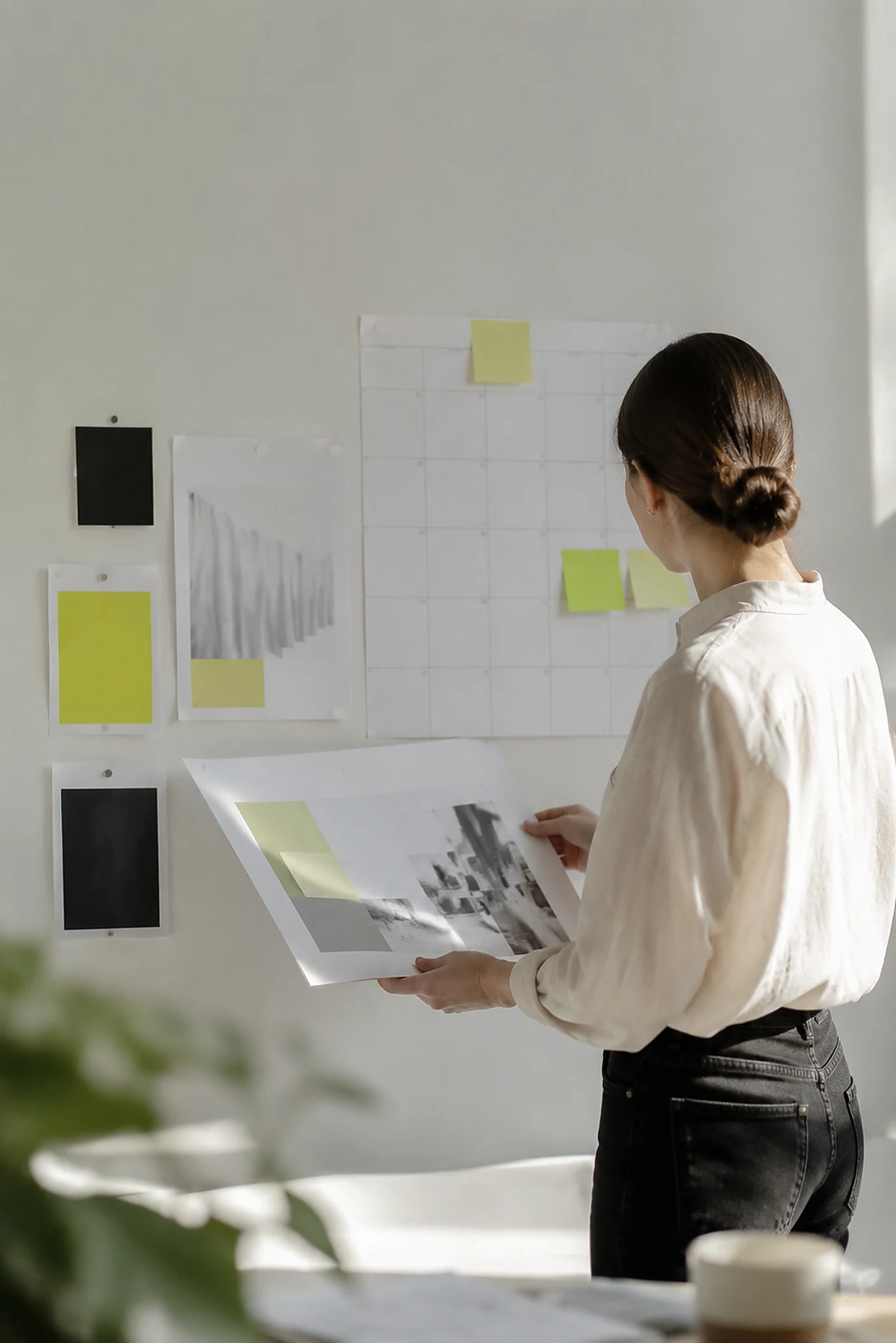 Account lead working through a project plan at a studio desk