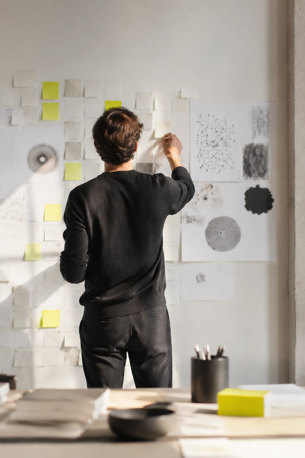 Strategist mapping audience research on a wall of notes
